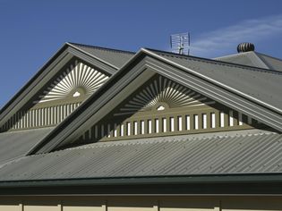 House roof with standing seam metal panels